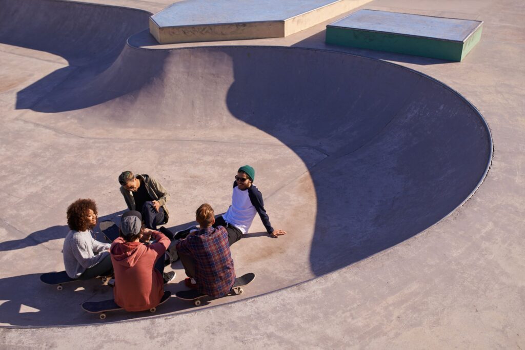 friends hanging out sun-skate park